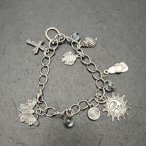 Silver tone charm bracelet sun fish cross shell